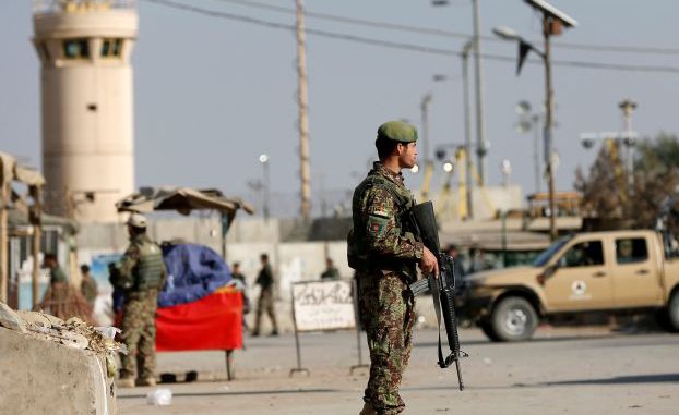 Afghan National Army (ANA) soldiers keep watch outside the Bagram Airfield entrance gate, after an explosion at the NATO air base, north of Kabul